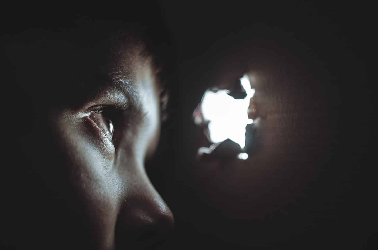 A boy is looking through a small window. It is a representative of the power of EMDR therapy.
